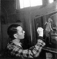 Lucien Coutaud dans son atelier montrant ses oeuvres en 1941